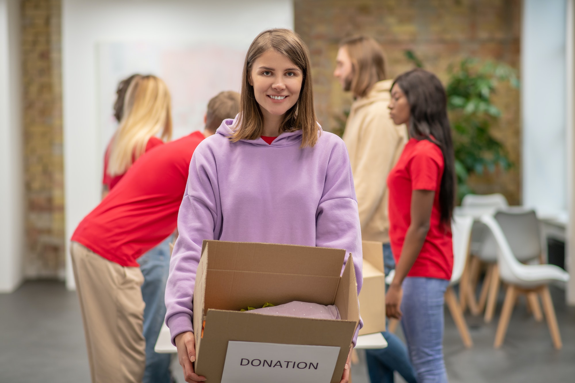 Volunteers working in a donations distribution center